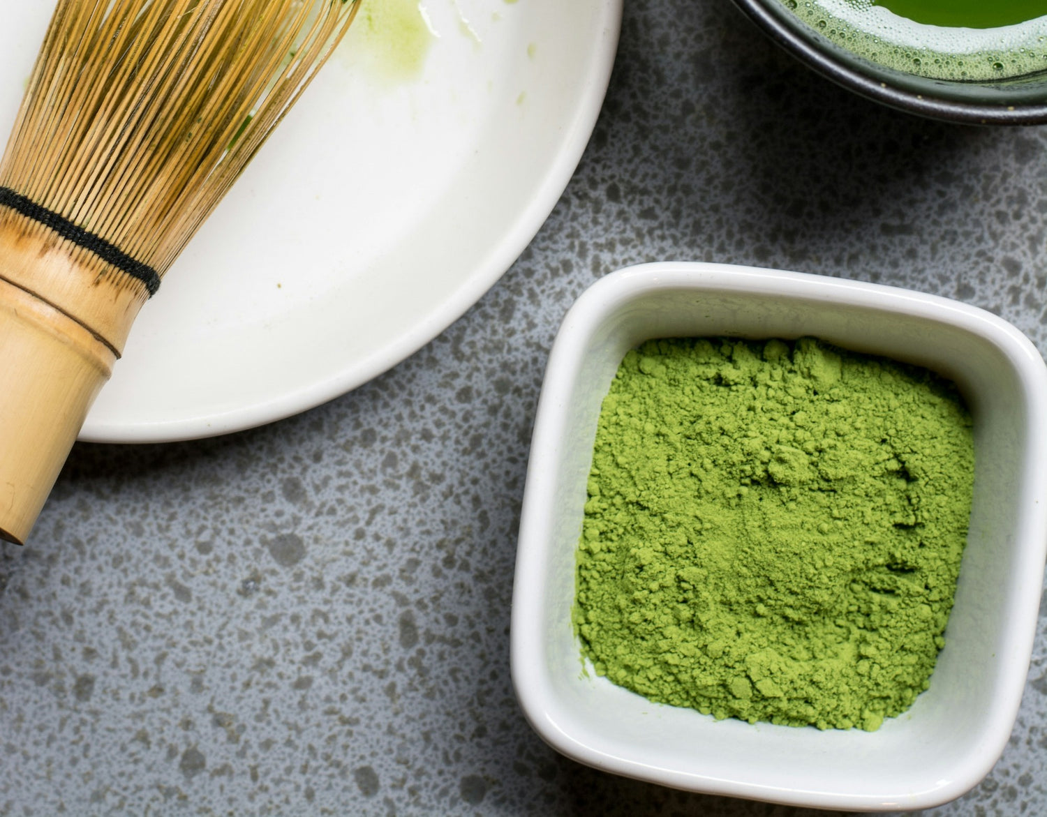 An array of vibrant super greens supplements in various forms such as powders, pills, and smoothies, surrounded by fresh green vegetables and fruits on a sunny wooden kitchen countertop, with a mornin